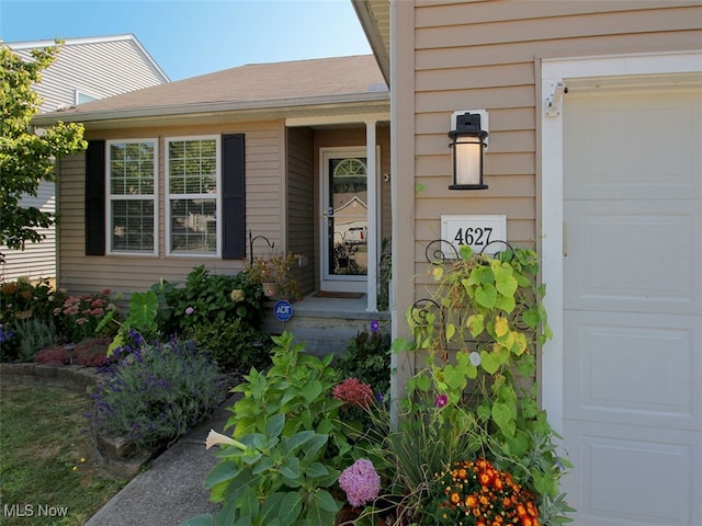 doorway to property with a garage