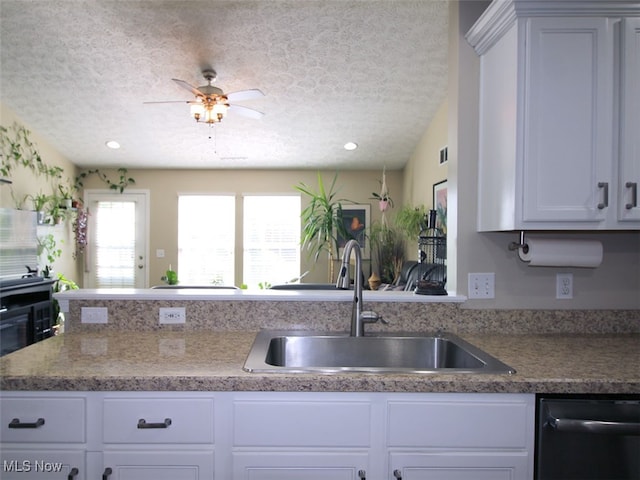 kitchen featuring white cabinets, sink, a textured ceiling, and dishwasher