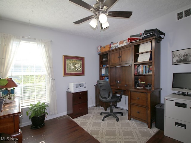 office area featuring ceiling fan, light wood-type flooring, and a textured ceiling