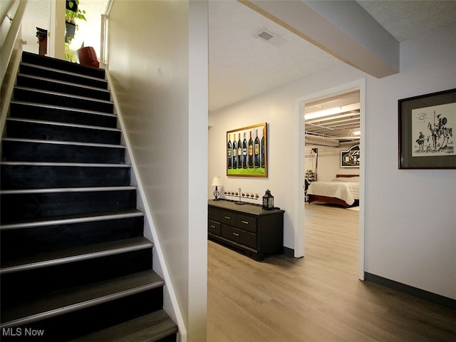 stairs featuring wood-type flooring