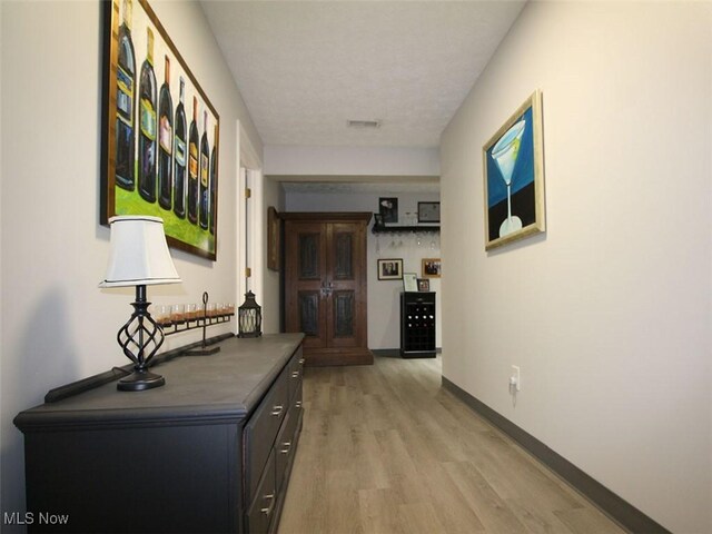 hall with light hardwood / wood-style floors