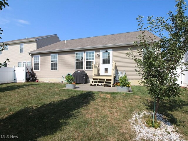 back of property featuring a lawn