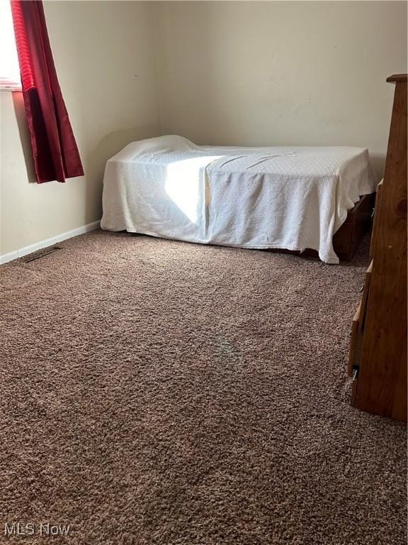 carpeted bedroom featuring baseboards