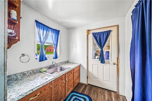 kitchen with dark hardwood / wood-style flooring and sink