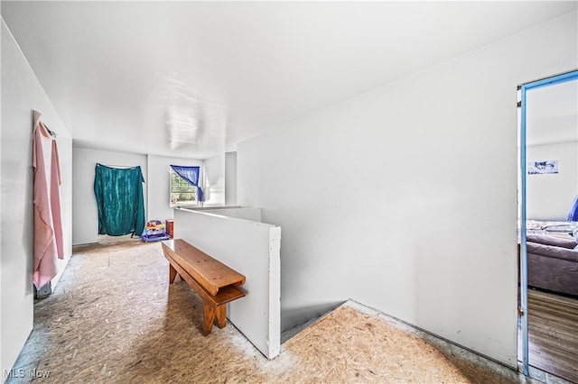 hallway with hardwood / wood-style floors