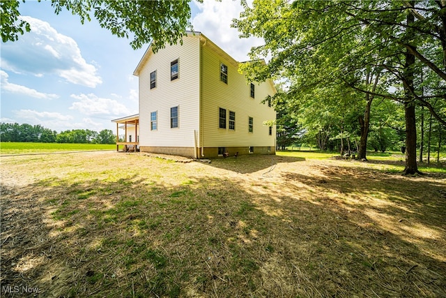 view of side of property with a lawn