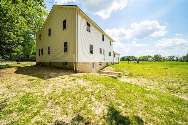 view of side of property with a lawn