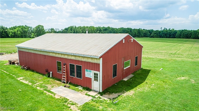 view of outbuilding featuring a yard and a rural view