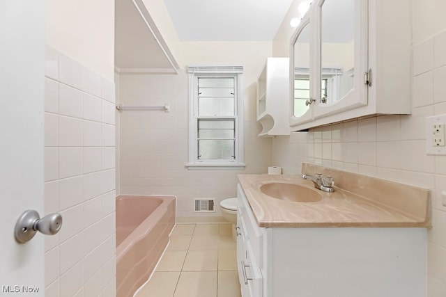 bathroom with tile walls, tile patterned floors, vanity, and toilet