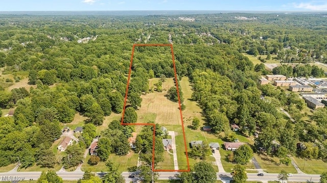 drone / aerial view featuring a view of trees