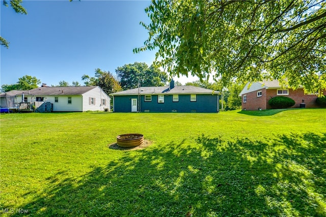 view of yard with an outdoor fire pit