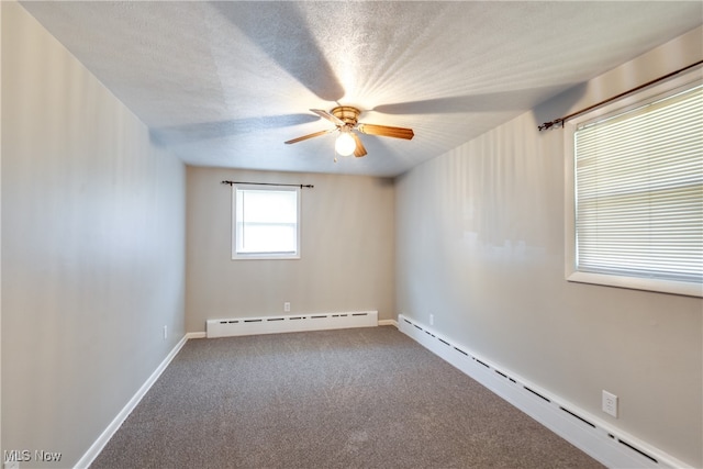 carpeted spare room with a textured ceiling, a baseboard radiator, and ceiling fan