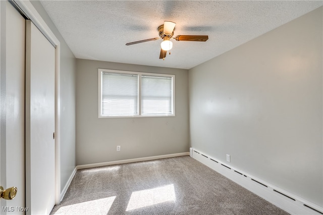 unfurnished bedroom with a textured ceiling, a baseboard radiator, ceiling fan, and carpet floors