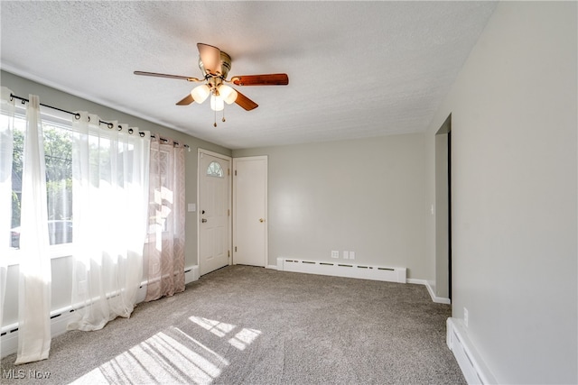 empty room with ceiling fan, baseboard heating, light carpet, and a textured ceiling