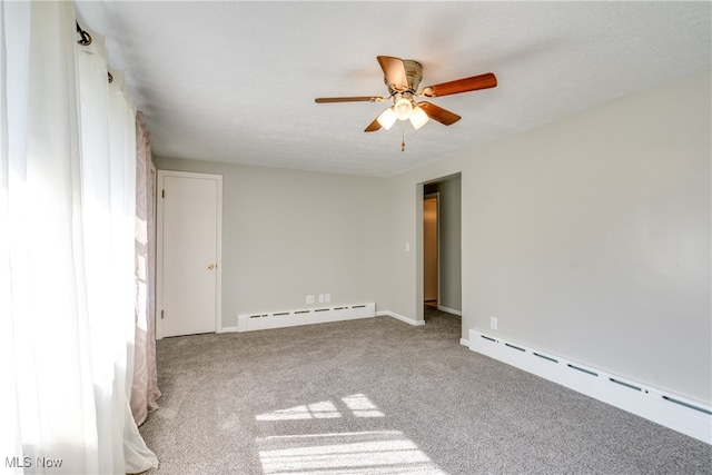 carpeted spare room with a baseboard heating unit, a textured ceiling, and ceiling fan