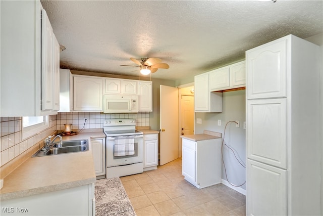 kitchen featuring white appliances, sink, decorative backsplash, white cabinetry, and ceiling fan