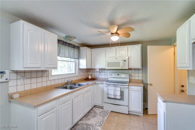 kitchen with white cabinets, white appliances, sink, and ceiling fan