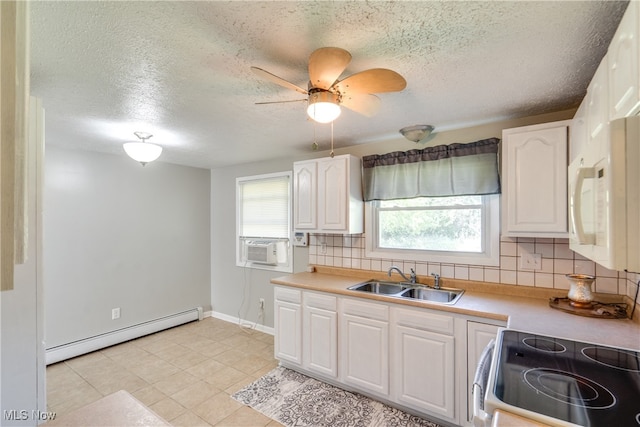 kitchen featuring a baseboard heating unit, backsplash, white cabinetry, and sink