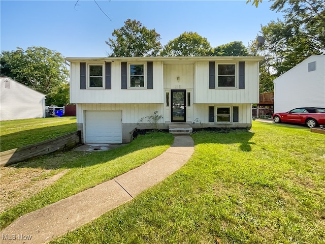 split foyer home with a garage and a front yard