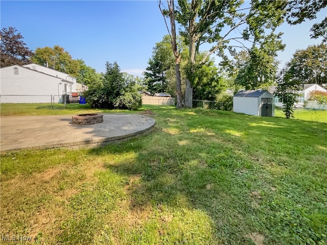 view of yard with a storage unit and a patio