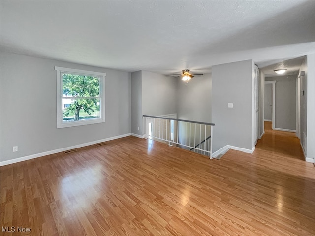 unfurnished room with hardwood / wood-style floors and ceiling fan