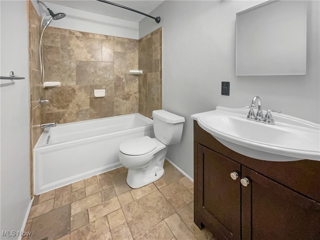 full bathroom featuring tiled shower / bath combo, vanity, toilet, and tile patterned flooring