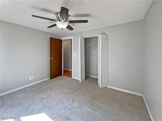 unfurnished bedroom featuring carpet, ceiling fan, and a closet