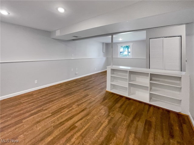 basement with hardwood / wood-style flooring