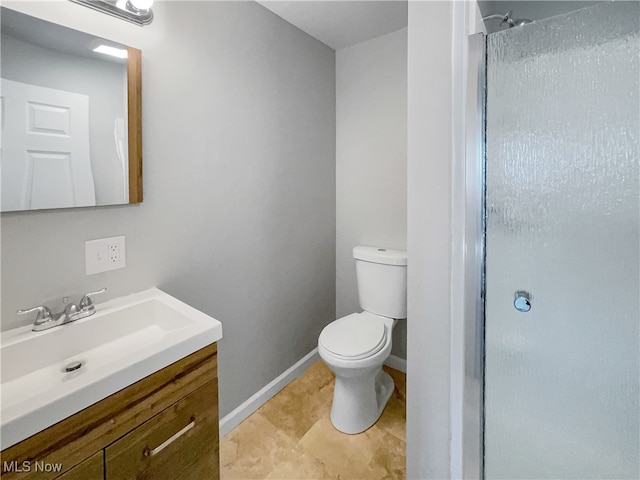 bathroom with vanity, toilet, walk in shower, and tile patterned flooring