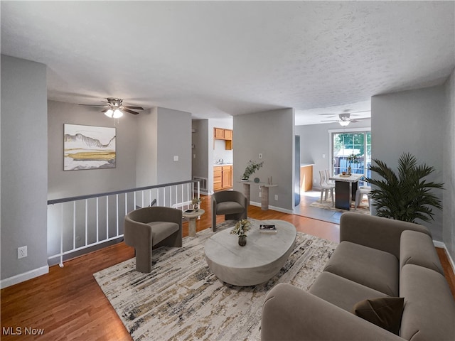 living room with ceiling fan and hardwood / wood-style floors