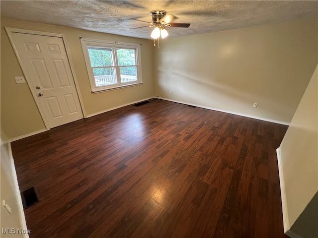 unfurnished room featuring ceiling fan, a textured ceiling, and dark hardwood / wood-style flooring