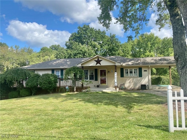 ranch-style house featuring a shingled roof, an attached carport, a front lawn, a porch, and central AC