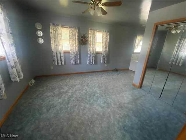 spare room featuring carpet and ceiling fan