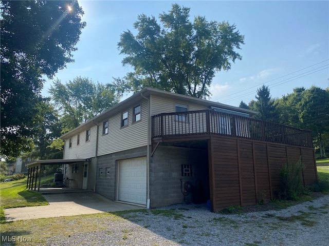 view of side of property featuring a garage and a carport