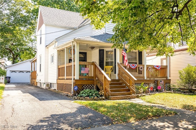 view of front of home with a garage, an outdoor structure, and a porch