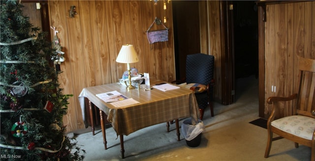 office area featuring wood walls and carpet flooring