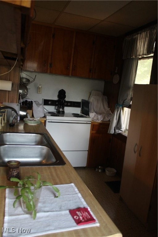 kitchen featuring sink, electric stove, and a drop ceiling