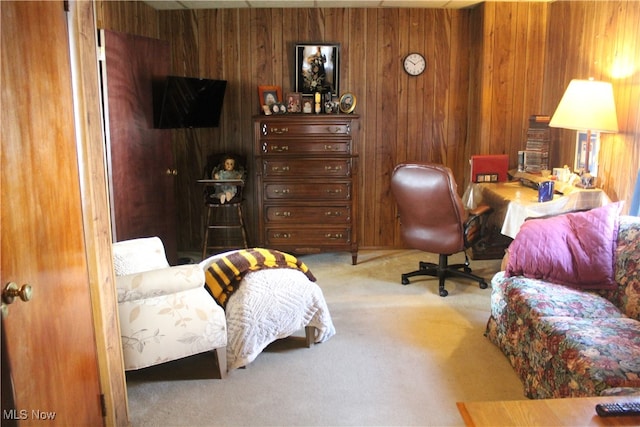 carpeted office space featuring wooden walls