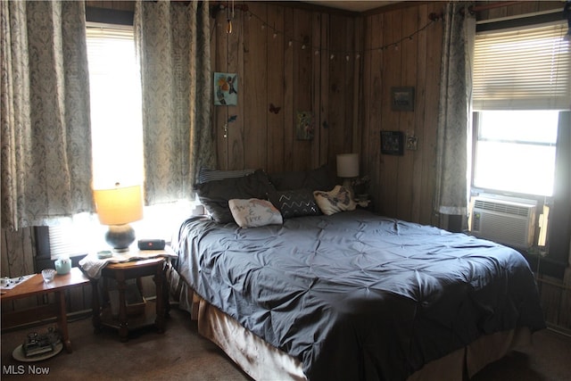 bedroom featuring carpet, wooden walls, and cooling unit