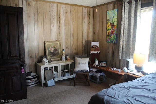 bedroom with wood walls and carpet