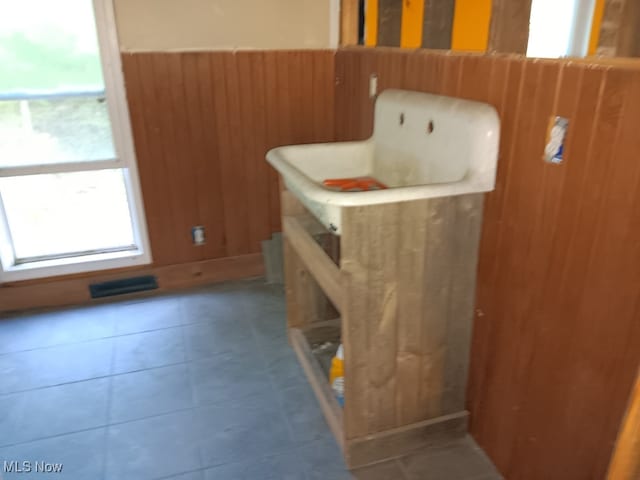 interior space featuring wood walls and tile patterned floors