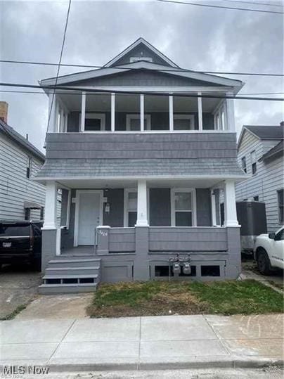 view of front of house featuring a balcony and a porch