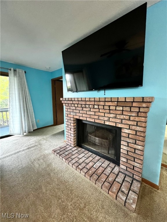 room details featuring carpet and a brick fireplace