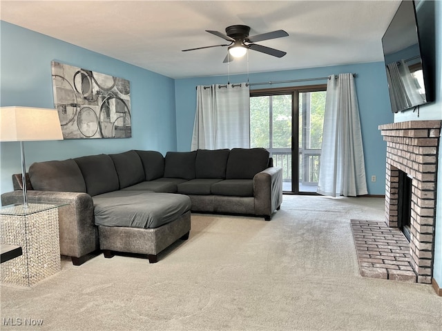 carpeted living room with a brick fireplace and ceiling fan