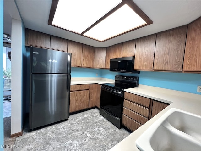 kitchen with sink and black appliances