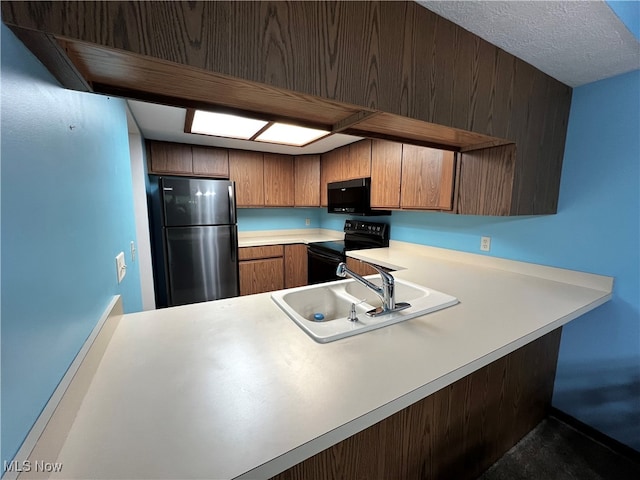 kitchen with black appliances, sink, and kitchen peninsula