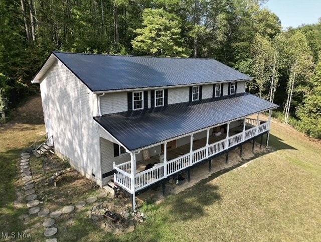 rear view of house with a porch and a lawn