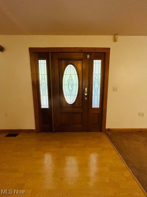 carpeted foyer entrance with plenty of natural light