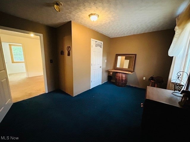 carpeted bedroom featuring a textured ceiling