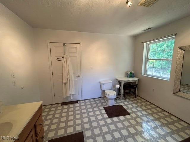bathroom featuring tile patterned floors, vanity, and toilet